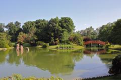 serene Japanese garden with lush greenery and a tranquil pond