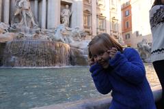 Trevi Fountain with coins being thrown by tourists