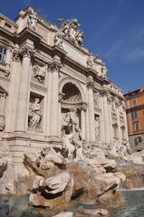 Cityscape of Rome featuring historical architecture with a cloudy sky