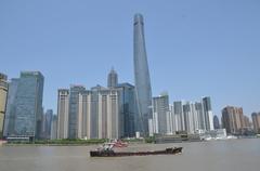 A distant view of the Shanghai Financial Tower from the Huangpu River with the Pudong skyline in the background