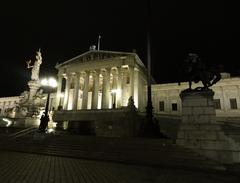 Austrian Parliament Building at night with statues