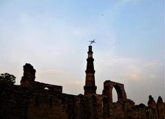 an aircraft flies over the Kutub Minar