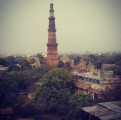 Aerial view of Qutub Minar surrounded by lush greenery in Delhi