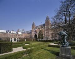 view of the garden with trimmed boxwood hedges and the back side of Rijksmuseum in Amsterdam