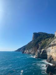 Scenic coastal view in Porto Venere, Liguria with the Ligurian Sea hitting the rocks on a warm summer day