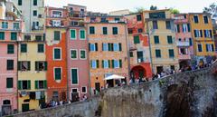 picturesque view of Riomaggiore village in Cinque Terre National Park with colorful houses nestled on a rocky coastline