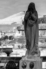 Ancient statue in sepia tone at a cemetery