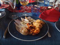 Finnish Christmas food with ham, casseroles, white wine, and water