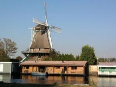 Windmill in Sloten, Amsterdam with houseboats in the foreground