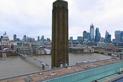 City of London skyline with St Paul's Cathedral, Millennium Bridge, and Bankside Power Station chimney as seen from the Switch House panoramic platform