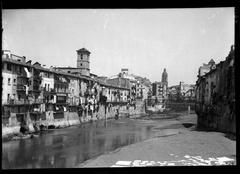 View of the Onyar River in Girona with the Iron Bridge and the Sant Feliu bell tower in the background