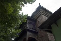 Interior view of Khanqah-e-Moula with intricate wooden architecture and traditional design