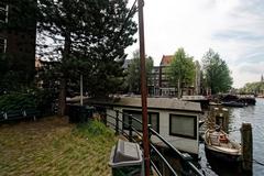 Panoramic view of Oudeschans canal, Montelbaanstoren tower, and surrounding areas in Amsterdam