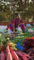 woman vendor selling fresh farm produce