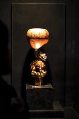 prehistoric pottery exhibit in a well-lit museum display