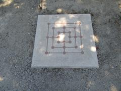 Roman hopscotch game carved into stone slabs at the Hortus Garden in Arles Antique Museum