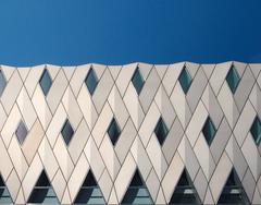 Modern high-rise building against blue sky in an urban European city