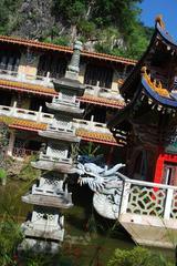 Sam Poh Tong Cave Temple garden with mini pagoda and dragon boat