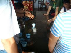 tourists interacting with water at Poh San Teng Well, Hang Li Po Well nearby