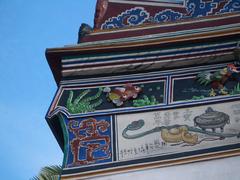 Poh San Teng temple relief fragment with ruyi scepter, censer, and sycees