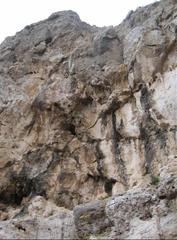 Entrance to Benzú cave surrounded by rocky walls