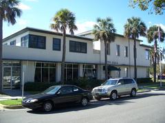 Fernandina Beach City Hall building with a clock tower and palm trees