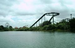 View of Thorpe Park from across Manor Lake with various rides visible