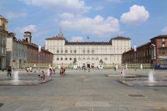 Aerial view of Torino cityscape with notable landmarks and mountains in the background