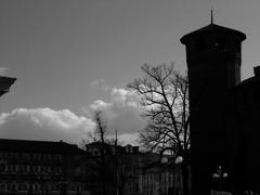 silhouette of a tower of Palazzo Madama against a cloudy sky