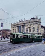 Green tram in Turin with Palazzo Madama in the background