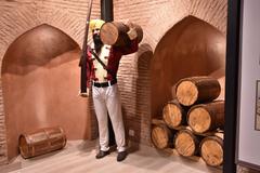 Mannequin of a Sikh gentleman carrying a keg on his shoulder