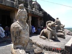 Ancient rock-carved statues of Great Sages Narada, Thumbura, and an unknown sage in Ananta Padmanabha Caves