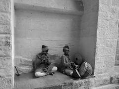 Live art depicting traditional Rajasthani musicians with cultural instruments on a wall