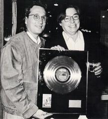 Tom Jobim receiving gold record for Passarim from manager Alberto Traiger