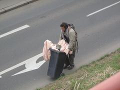 man with a trashcan in Libeň