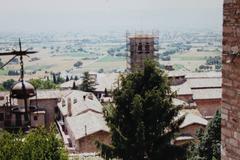 Panoramic view of Assisi, Italy with historic buildings and green landscapes