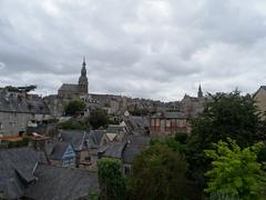 Scenic view of Dinan with historic buildings and lush greenery