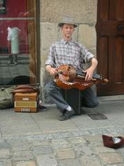 Hurdy gurdy player in street, Dinan