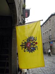 A picturesque street in Dinan's old town with a flag