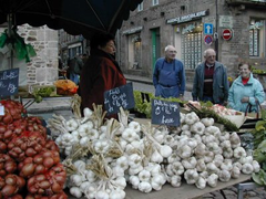 Market in Dinan, Brittany selling garlic and onions