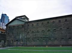 Exterior view of Old Melbourne Gaol with surrounding greenery