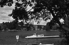 View of Vanhankaupunginkoski from Pornaistenniemi with a motorboat docked in the foreground