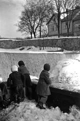 Children watching Vanhankaupunginkoski river during ice melting