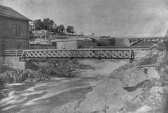 Old walking bridge over Vanhankaupunginkoski with Vanhankaupungin steam pumping station construction site in the background