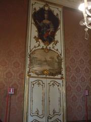 interior view of Sala Rossa with elegant red furnishings and chandeliers