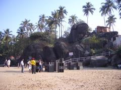 Scenic view of Palolem Beach during sunset with boats and palm trees