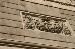 Left side of Porta Garibaldi city gate relief with wreath and caduceus in Milan