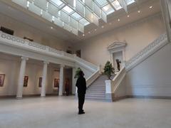 People in the lobby of the New Orleans Museum of Art looking up at the ceiling