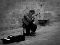 Musician performing guitar solo on a street in Barcelona