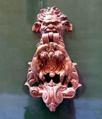 ornate door knocker on a wooden door in Santa Sofia Street